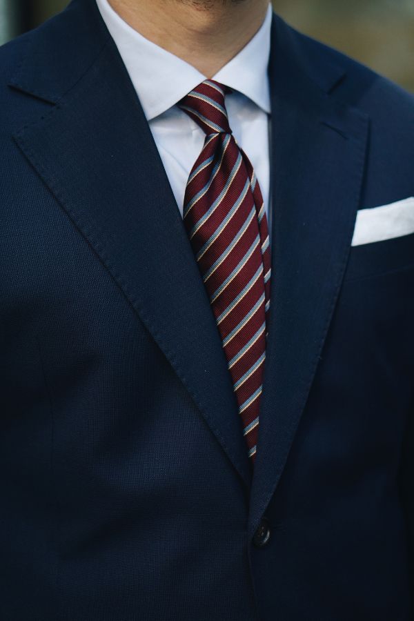 navy suit with white shirt and stripe tie